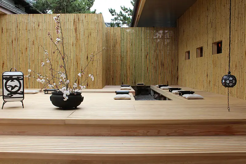 Traditional onsen ryokan exterior with wooden architecture and garden